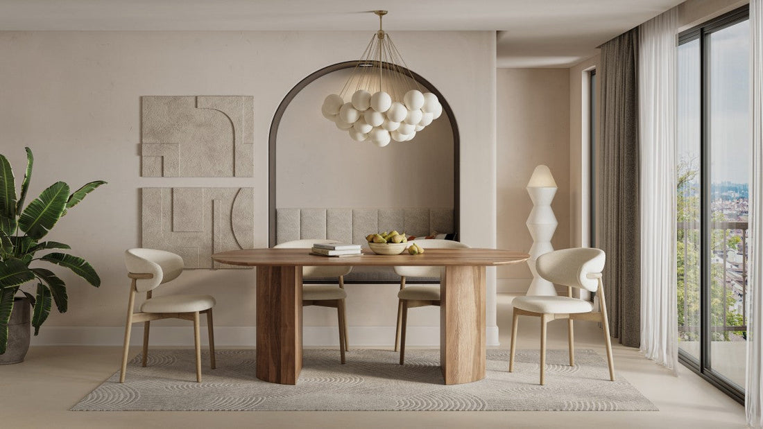 Oval solid mango wood dining table with natural grain finish surrounded by modern upholstered chairs in a bright contemporary dining room.